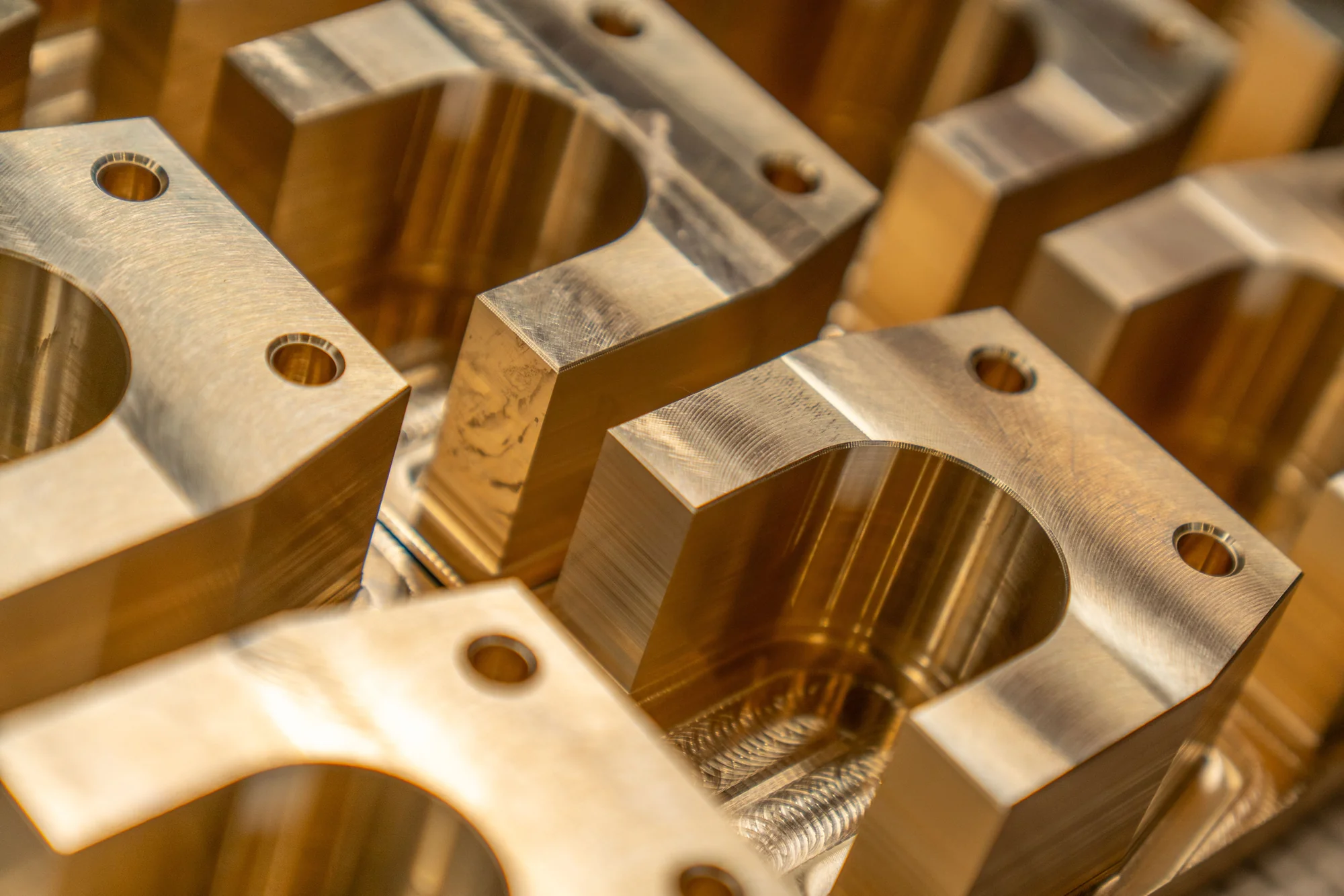 Close-up of precision-machined metal components with milled edges and drilled holes